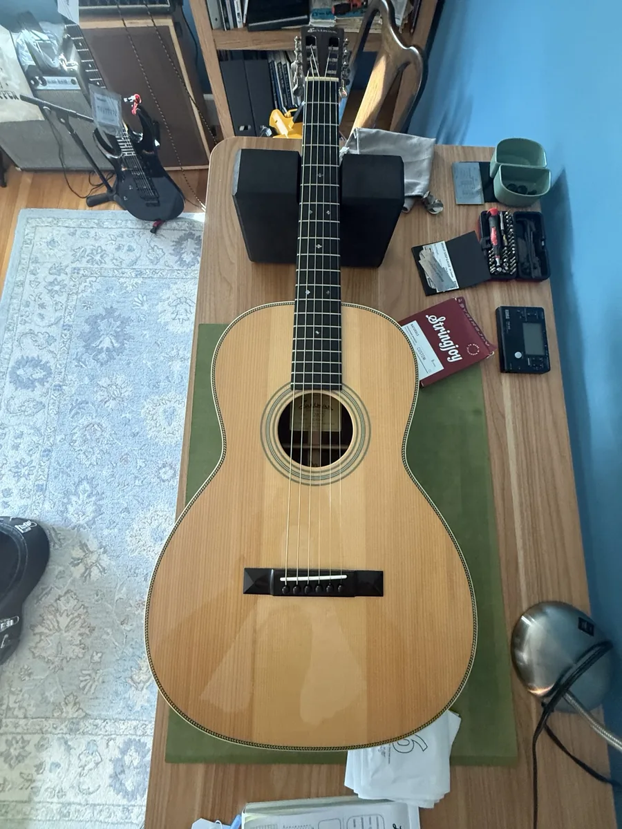 2015 Eastman E20 OO acoustic guitar on a repair bench