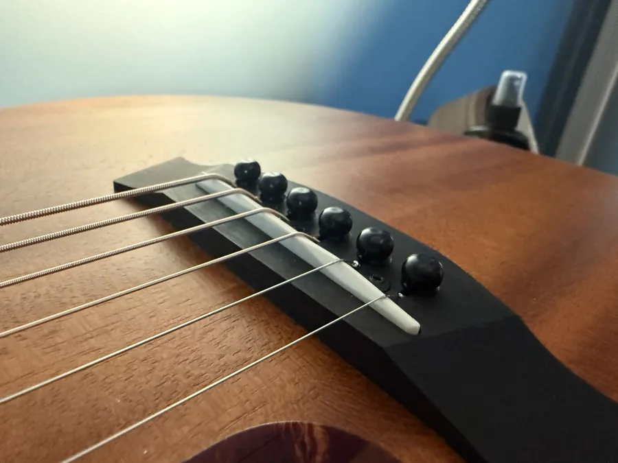Acoustic guitar fingerboard being cleaned and conditioned with the strings off