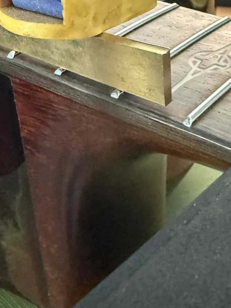 Acoustic guitar bridge during cleaning and maintenance