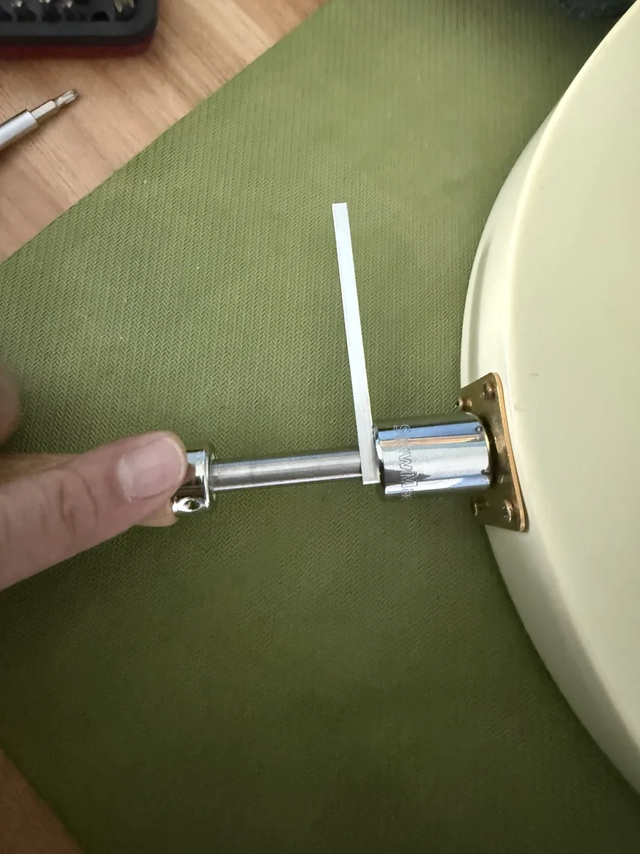 Jack-the-Gripper seated in the Les Paul output jack, socket over the nut, handle bar held steady while the nut is turned