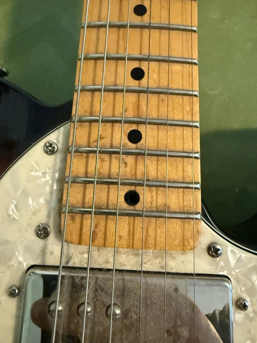 Maple fretboard on an older Squier before cleaning
