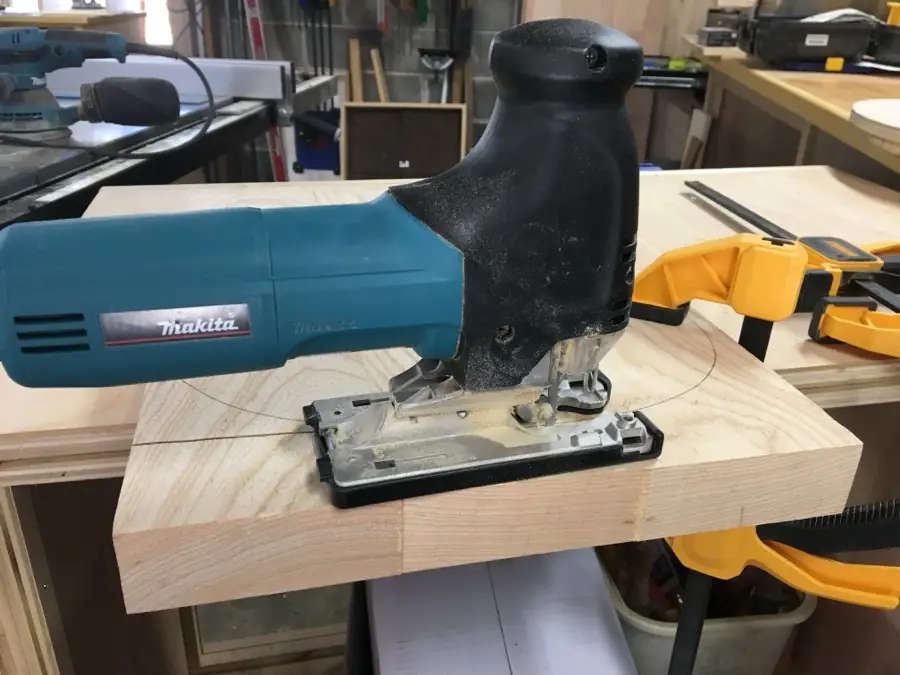 Jigsaw cutting the rough outline of a guitar body blank