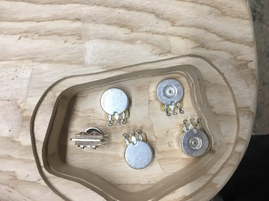 Potentiometers and switch test-fitted into a routed control cavity